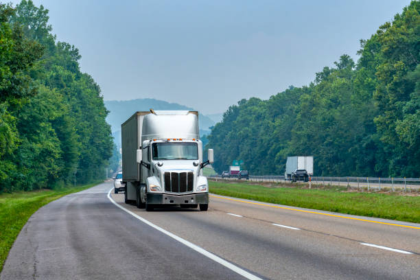 White Eighteen-Wheeler on Interstate With Room To Crop stock photo