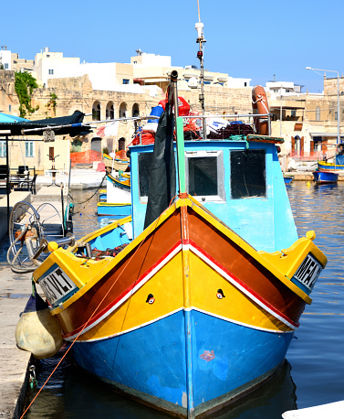 Traditional Maltese Luzzu fishing boat.  Note the eyes on the bow.  Photograph taken at Marsaxlokk Harbor, Malta