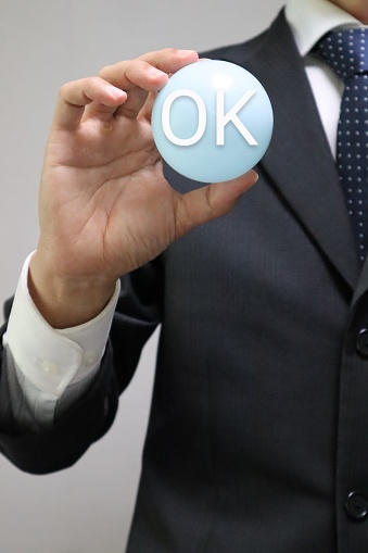 Photo of a person holding a ball that says OK