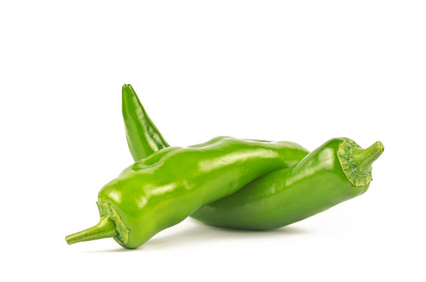 Pair of Jalapenos (Green Chilies) A pair of large size Jalapenos (Green Chilies) on white background. green chilli pepper stock pictures, royalty-free photos & images
