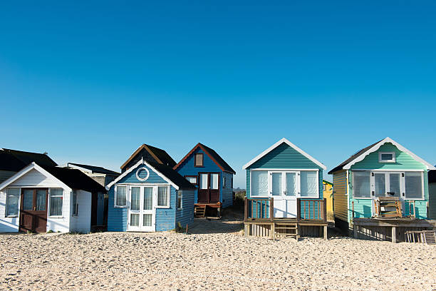 Beautiful beach huts near the shores on a sunny day Huts at Hengistbury Head near Christchurch in Dorset. England christchurch england photos stock pictures, royalty-free photos & images