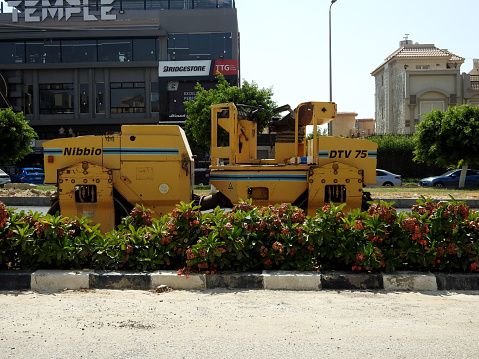 Cairo, Egypt, July 21 2023: Asphalt compactor paver truck, A paver (road paver finisher, asphalt finisher, road paving machine) is a piece of construction equipment used to lay asphalt concrete, selective focus