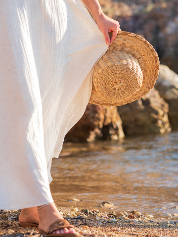 woman walking on the beach in white dress
