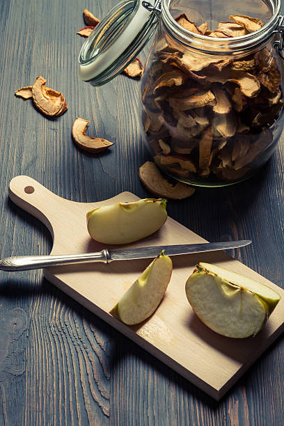 istock Raw and dried apple in jar on old table 161732224