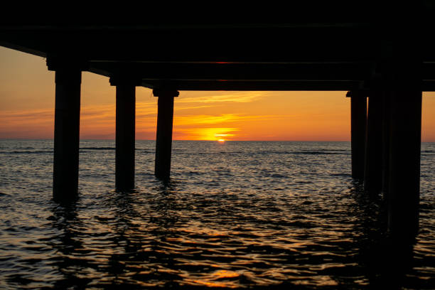 istock Golden Hour: Pier and Sea During the Sunset 1617341071