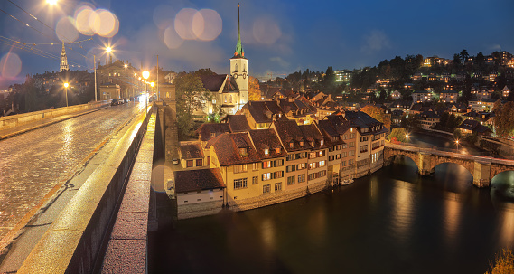 Incredible  autumn view of Bern city at night. Scene of Aare river with Nydeggkirche - Protestant church. Location: Bern, Canton of Bern, Switzerland, Europe