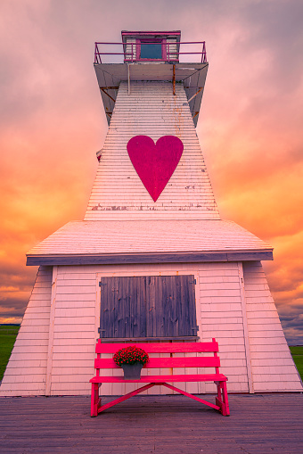 Port Borden Pier Lighthouse, historical landmark in Borden-Carleton, Prince Edward Island, Canada, a stormy sunset landscape