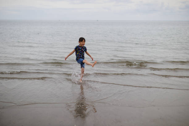 istock young girl was playing at summer beach 1617373887