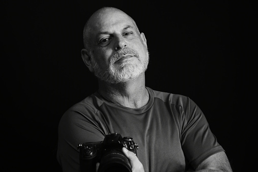 photographer portrait of man holding photo camera record of images clicks
