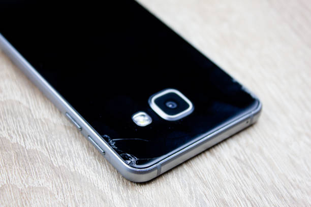 istock Cracked smartphone from the back. Fall damage to smartphone. Broken smartphone. 1617377033