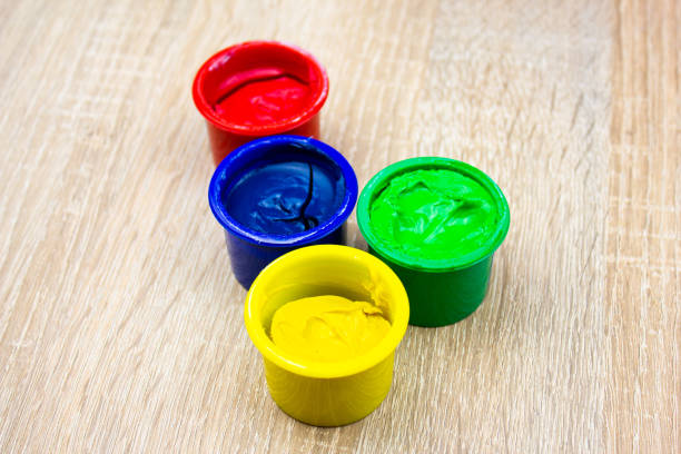 Gouache paints in jars. Multi-colored paints for art on the table.