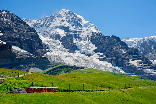 A train passes by the mountains at the Kleine Scheidegg, Jungfrau region, Switzerland