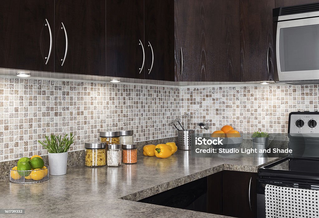 Modern kitchen with cozy lighting Modern kitchen with cozy lighting, and food ingredients on the counter top. Kitchen Stock Photo