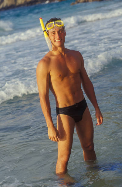 Young man with mask an snorkel on the beach, Margarita Island, Venezuela