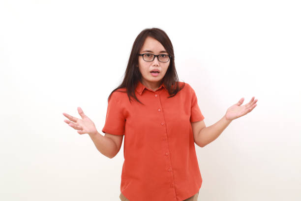 istock Confused young asian woman standing with question hand gesture. Isolated on white 1617448008