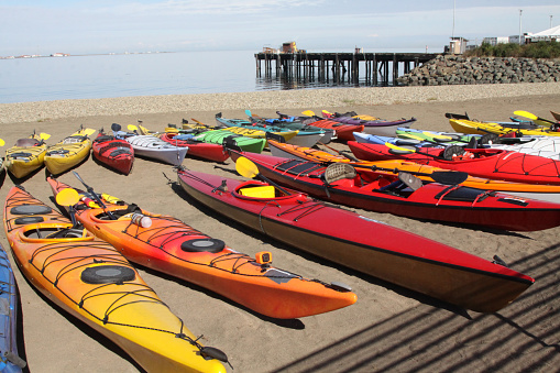 Brightly colored kayaks on the beach ready for competition