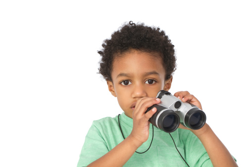 little boy holding binoculars with copy space, isolated on white background
