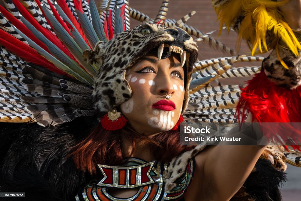 Aztec Warrior Princess looks into the sun. Girl in Aztec Costume. Aztec Civilization Stock Photo