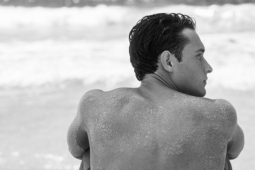 Man relaxing on the sand at the beach, Margarita Island, Venezuela