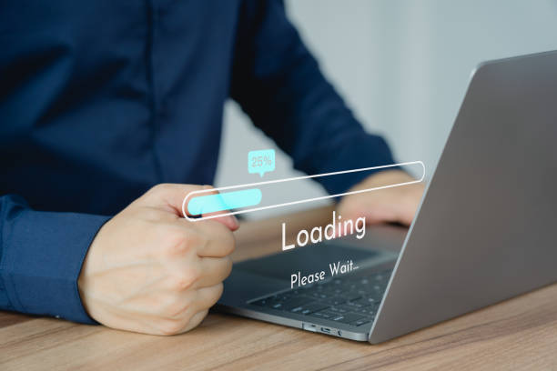 istock Adult man using a laptop computer for download and update software and waiting to loading digital file data form website, very slow internet form wifi. Concept of waiting for load of loading symbol. 1617542282