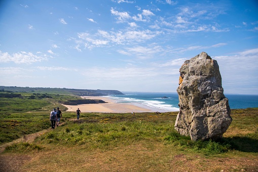 Crozon, France - May 17, 2022: People walking on the GR34 around Lostmarc'h Beach