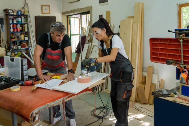 istock A Carpentry Worker is Carving a Wooden Plank. 1617559710