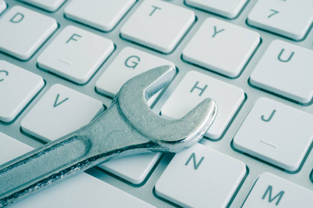 istock Wrench spanner on keyboard background. Customer online service center for troubleshooting quick support warranty claim concept. Computer technology product, laptop, desktop, notebook, online internet. 1617567575