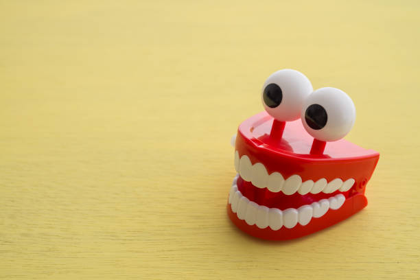 istock Chattering teeth toy wind up moving on yellow background. 1617570681