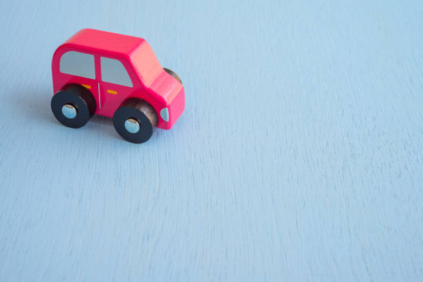 istock Red wooden car on blue background copy space. 1617581510