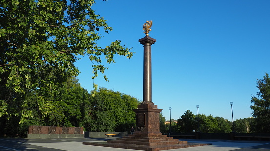 Petrozavodsk, Karelia, August 3, 2022 Monument-stele City of military glory, honorary title. Granite column with a bronze double-headed eagle. Pedestal on the alley of sister cities, Kirov Square.
