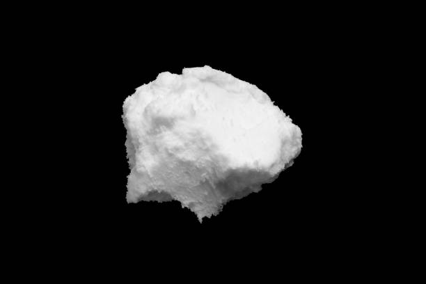 istock White snow isolated on black background close up 1617586207