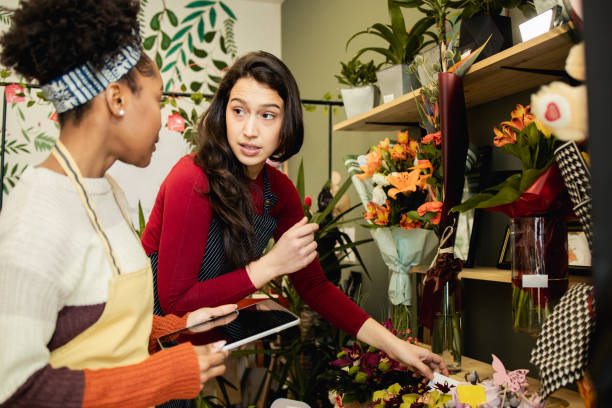 istock Flower shop employees work at their small business 1617591030