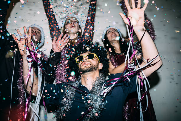 istock Group of friends dancing at night 1617594387