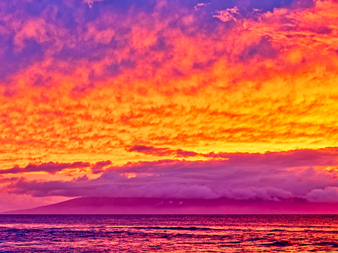 Dramatic sunset over the Island of Lanai seen from Maui in Hawaii