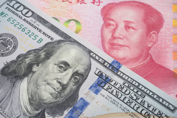 istock US dollar and Chinese yuan renminbi banknotes background. 1617616421