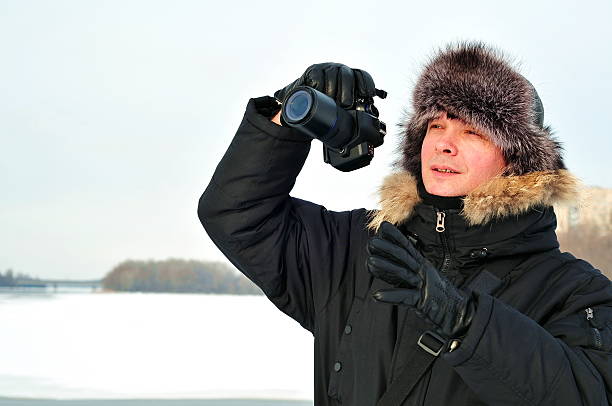 istock Young professional man with camera shooting outdoor 161761964