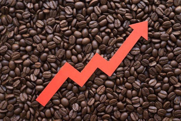 istock Red arrow chart graph soar rising up on coffee roasted arabica bean background. 1617624935