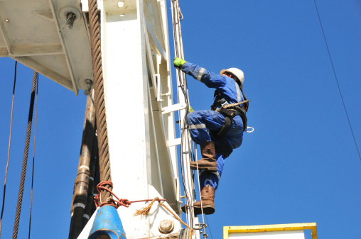 A derrickman climbing the drilling rig prior to making up connection.