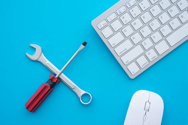 istock Flat lay of combination spanner or wrench, screwdriver, keyboard and mouse computer on blue background with copy space. 1617648809