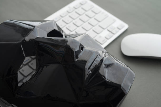 istock Black scary half face mask, keyboard and mouse on gray table background in dark tone. 1617652930