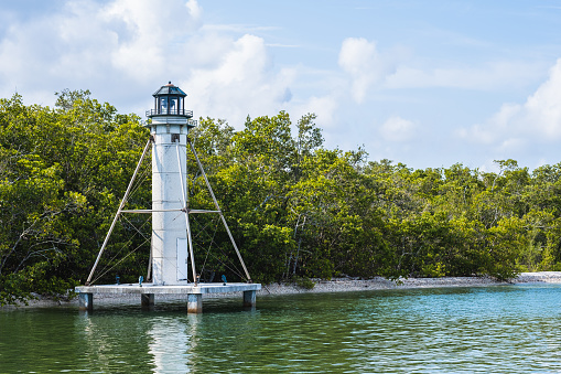 A small white lighthouse in Naples Florida
