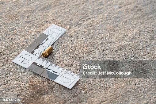 istock One crime scene evidence ruler on the street after a gun shooting 1617664916