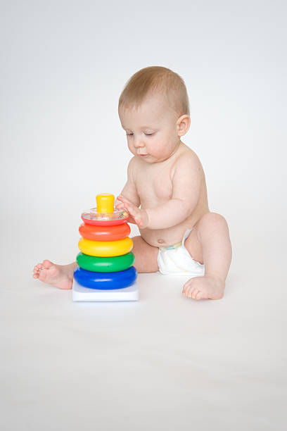 Cute baby playing with toy stock photo