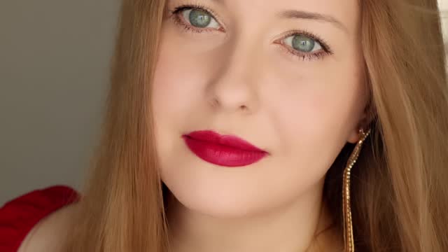 Beautiful happy smiling woman with long hair wearing red lipstick make-up, beauty blogger, influencer video stories reels for social media vlog