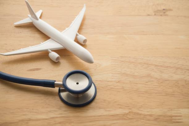 istock Airplane and stethoscope on wooden background with copy space. 1617701965