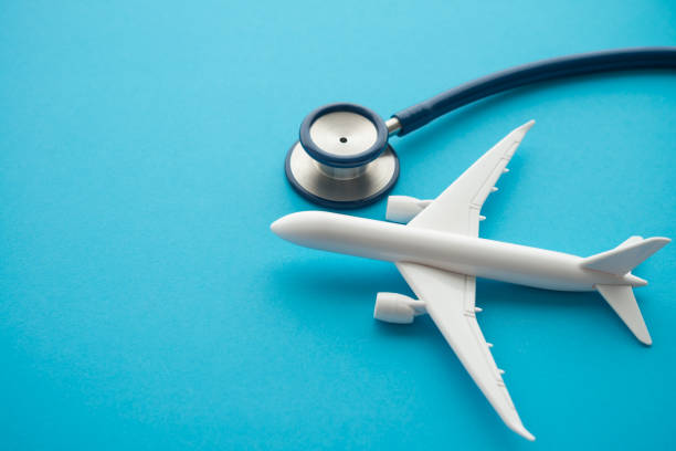 istock Airplane and stethoscope on blue background with copy space. 1617701973