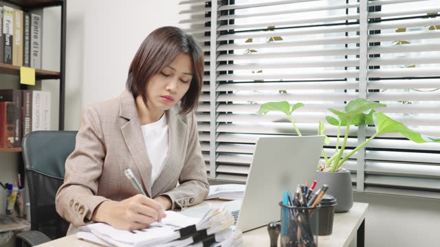 Accounting and Financial PlanningHand of Asian Woman analyzing business marketing data on paper dashboard at office table. Investment Analysis