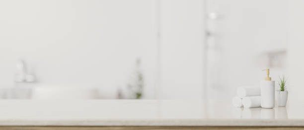 istock Copy space on a white tabletop with a blurred white elegance bathroom in background. 1617778236