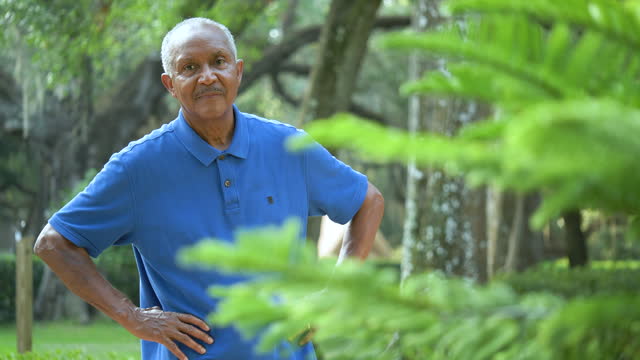 Senior African-American man in park, thinking