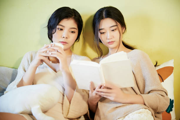 istock Asian best friends resting and relaxing on the sofa 1617836008